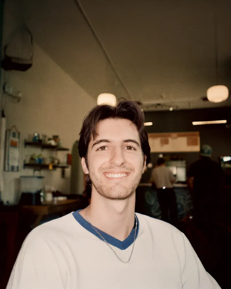 Emilio Roque smiling in a cafe